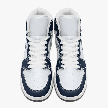 Overhead view of navy blue and white high-top sneakers showing clean white laces, white padded collar lining, and perforated white leather toe boxes.
