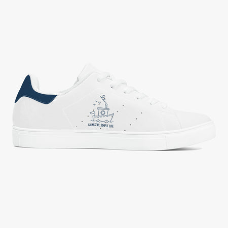 A white low-top sneaker with a dark navy heel tab, white laces, and a navy blue printed graphic on the side reading 'SALT WATER HALO EVERYTHING' with a small fish illustration.