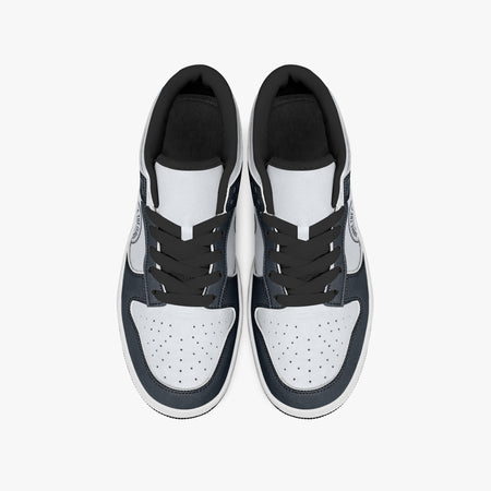 Overhead view of navy blue and off-white sneakers displaying black laces, black padded collar lining, and perforated white leather toe boxes.