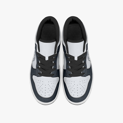 Overhead view of navy blue and off-white sneakers displaying black laces, black padded collar lining, and perforated white leather toe boxes.