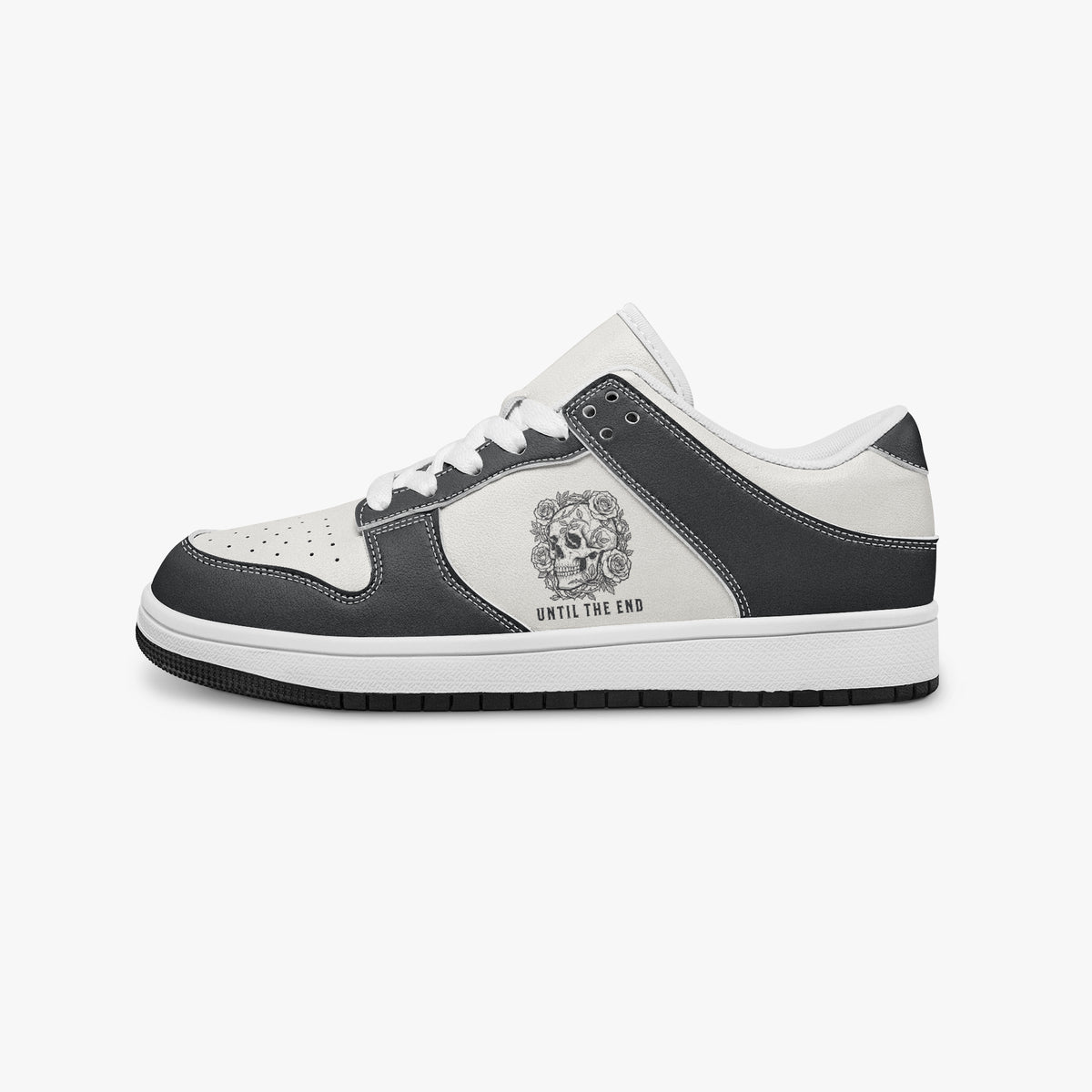 Side profile view of the left sneaker in black and white leather, highlighting the "UNTIL THE END" skull graphic, white laces, white interior lining, and flat rubber sole facing right.