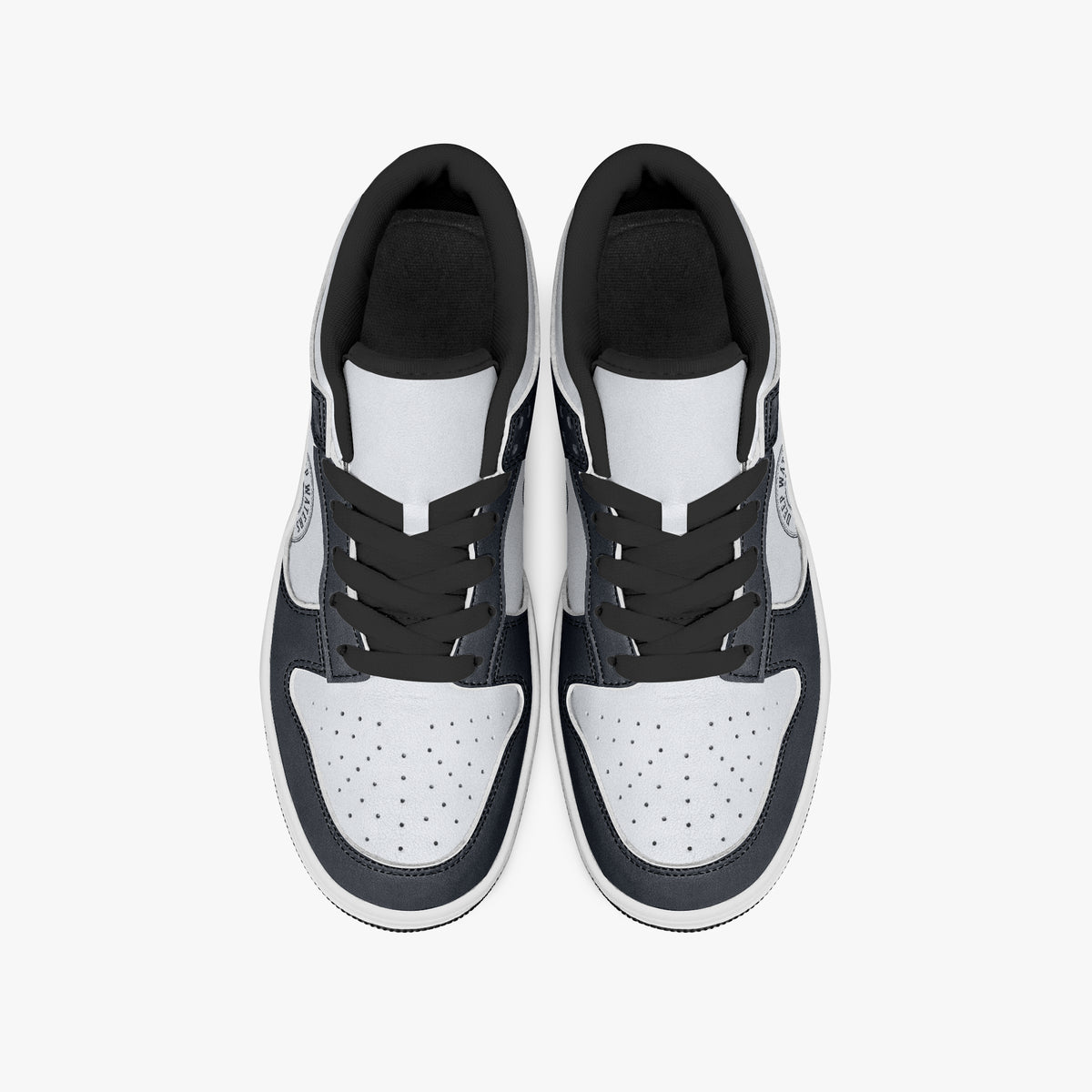 Overhead view of navy and white sneakers displaying black laces, black padded collar lining, and perforated white leather toe boxes.