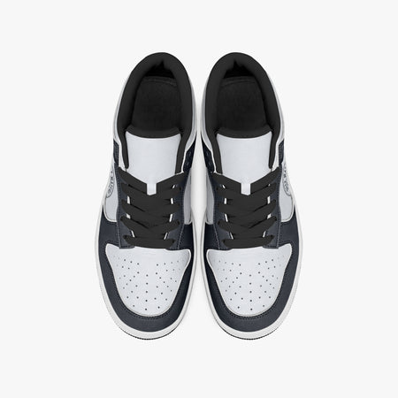 Overhead view of navy and white sneakers displaying black laces, black padded collar lining, and perforated white leather toe boxes.