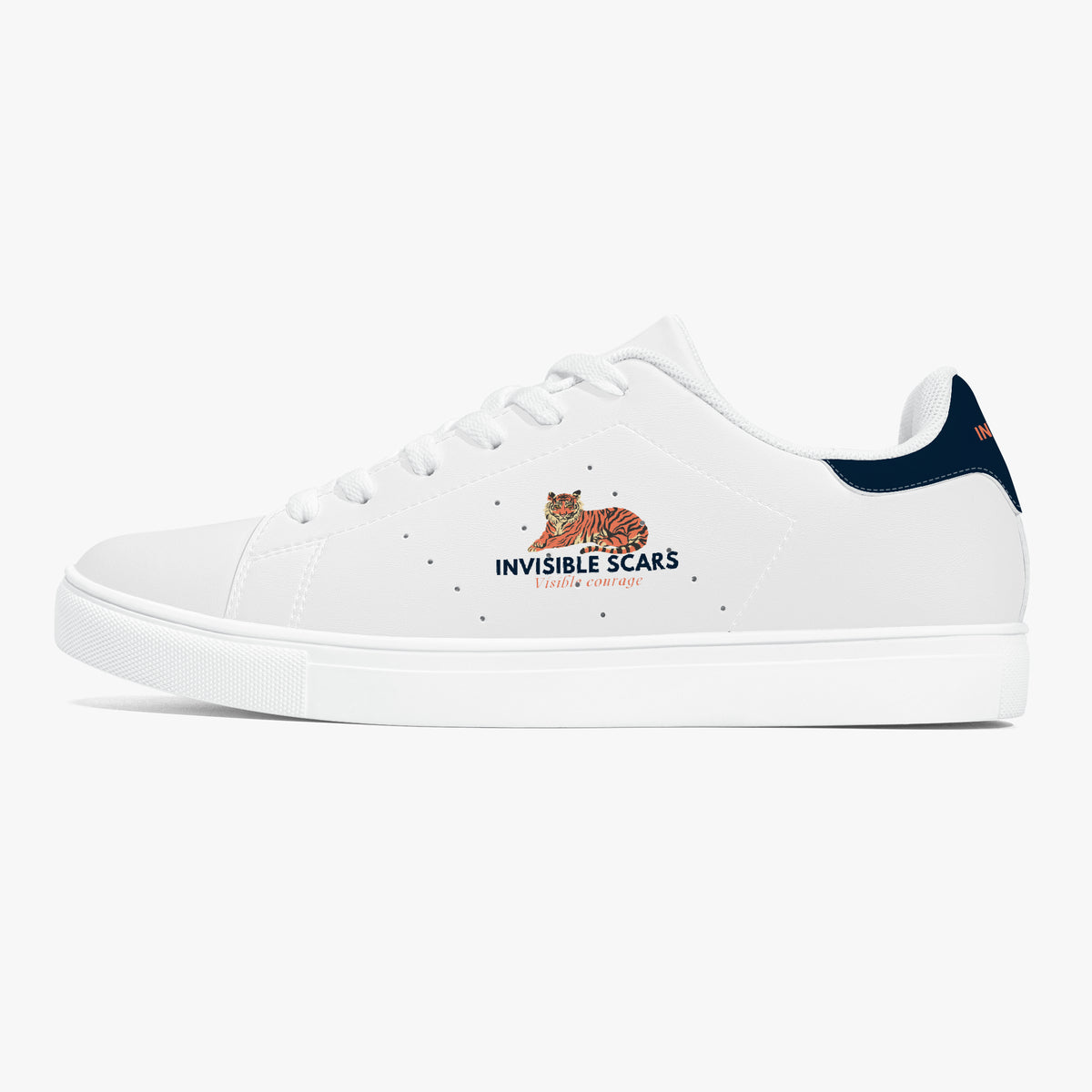 A white low-top sneaker with a navy blue heel tab, featuring a graphic of a tiger and the text 'INVISIBLE SCARS' printed on the side.