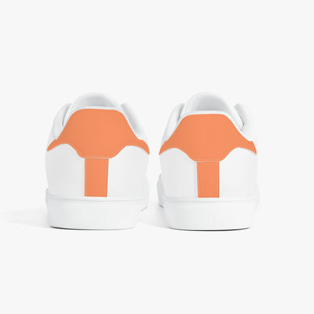 White sneakers with orange accents on a white background