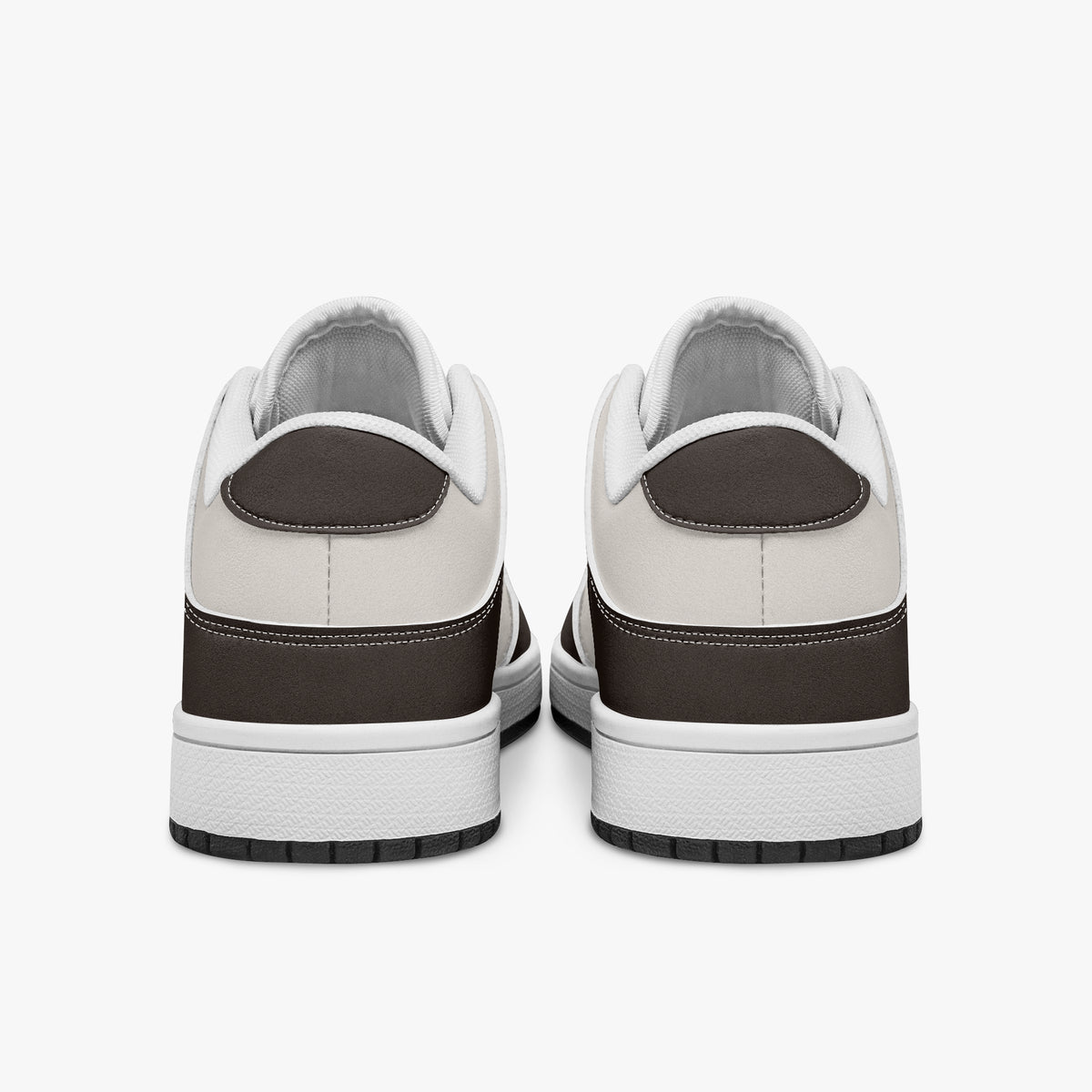 Rear view of brown and cream sneakers displaying espresso brown heel overlays, off-white leather collar panels, and two-tone white and black rubber outsoles.