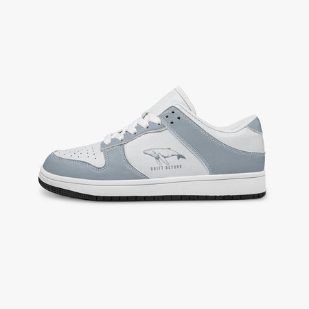 Side profile view of the left sneaker highlighting the slate blue-grey leather overlays, swimming whale emblem, white interior lining, and contrasting dark outsole facing right.

แบบที่ 2: เชือกสีดำ / ด้านในสีดำ (Black Lac