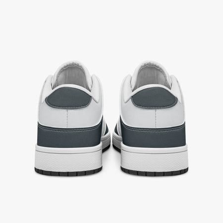 Rear view of slate blue-grey and white sneakers displaying blue-grey heel overlays, white leather collar panels, and two-tone white and black rubber outsoles.