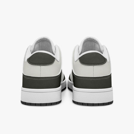 Rear view of olive-grey and off-white sneakers displaying dark heel overlays, off-white leather collar panels, and two-tone white and black rubber outsoles.