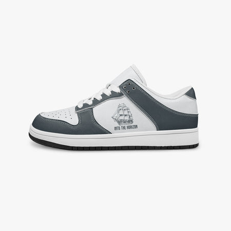 Side profile view of the left sneaker highlighting the slate blue-grey leather overlays, tall ship emblem, white laces, white interior lining, and contrasting black outsole facing right.