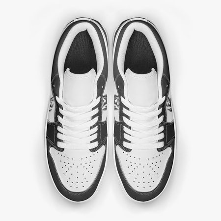 Overhead view of black and white sneakers showing clean white laces, white padded collar lining, and perforated white leather toe boxes.