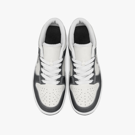 Overhead view of black and white sneakers showing clean white laces, white padded collar lining, and perforated white leather toe boxes.