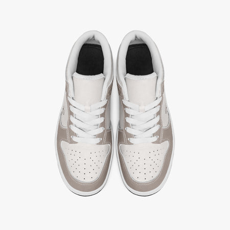 Overhead view of taupe and off-white sneakers showing clean white laces, white padded collar lining, and perforated off-white leather toe boxes.