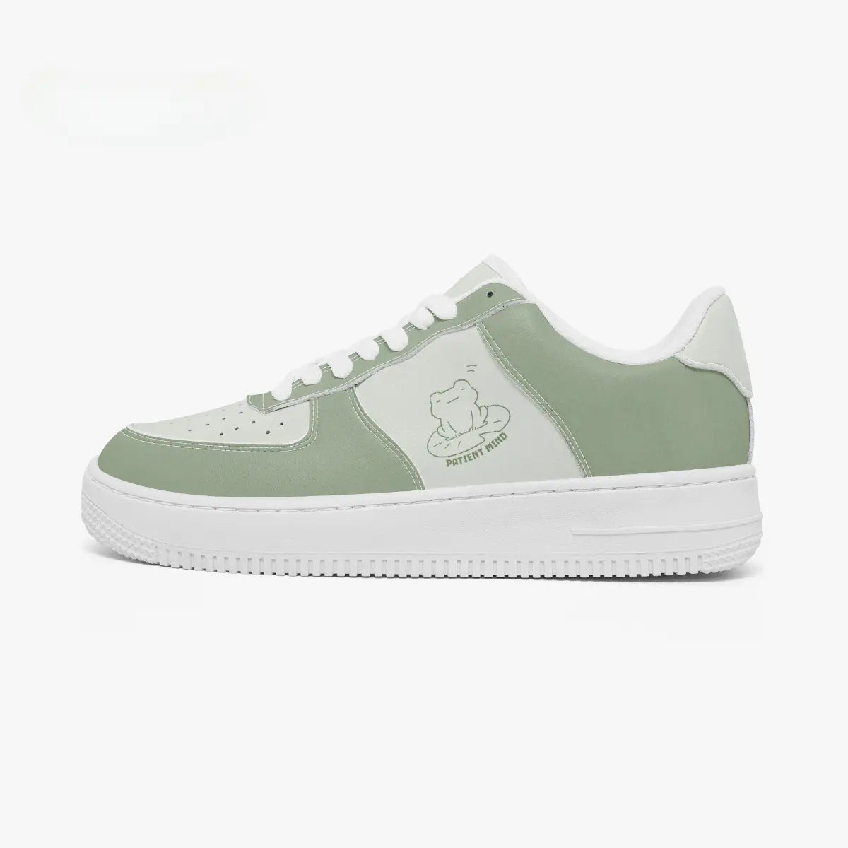Side profile view of the left sneaker in sage green and light mint leather, highlighting the "PATIENT MIND" frog illustration, sage green panels, white laces, and white cupsole facing right.