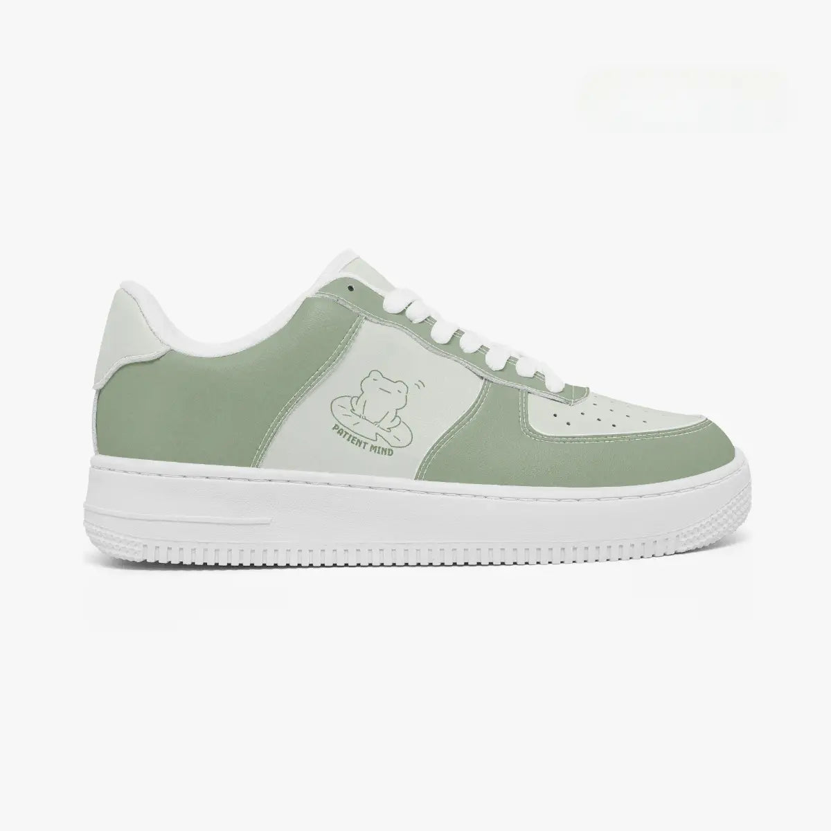 Side profile view of the right sneaker showcasing the sage green overlays, frog on a lily pad graphic, white eyestay trim, and flat white rubber sole facing right.