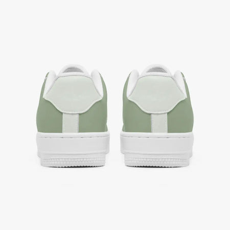 Rear view of sage green and mint sneakers displaying sage green heel overlays, light mint leather collar tabs, and textured white rubber platform midsoles.