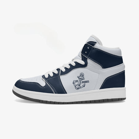 Side profile view of the left high-top sneaker in navy blue and white leather, highlighting the "STAY GROUNDED" anchor emblem, white collar lining, and solid rubber outsole facing right.
