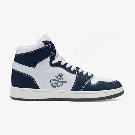 Alternative side profile view of the right high-top sneaker showcasing navy blue leather overlays, nautical anchor illustration, white eyelet lacing, and matching white midsole facing right.