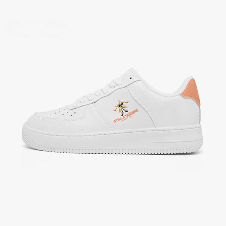 Outer side view of the left shoe in white leather, highlighting the star graphic, motivational text, and orange heel counter facing left.