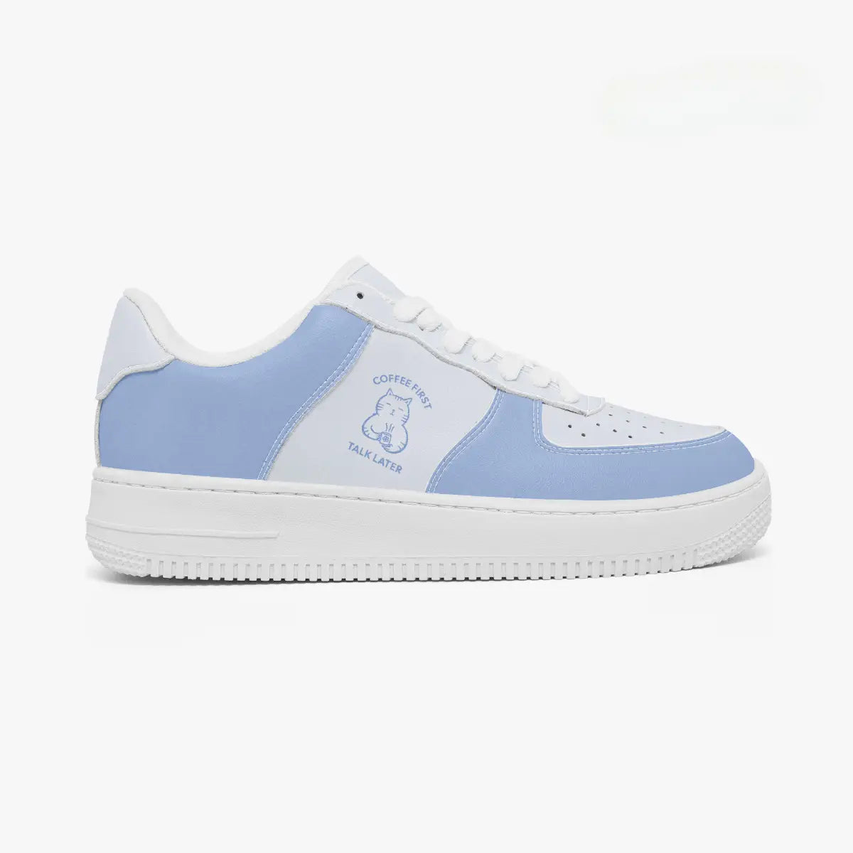 Side profile view of a low-top sneaker in white and periwinkle blue, featuring a "Coffee First, Talk Later" cat graphic on the side panel.