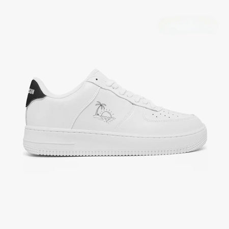 A white low-top sneaker shown in a side profile view against a clean white background. The shoe features a white leather upper, white laces, a thick white midsole, a small gray palm tree graphic on the side, and a black heel tab with white text.