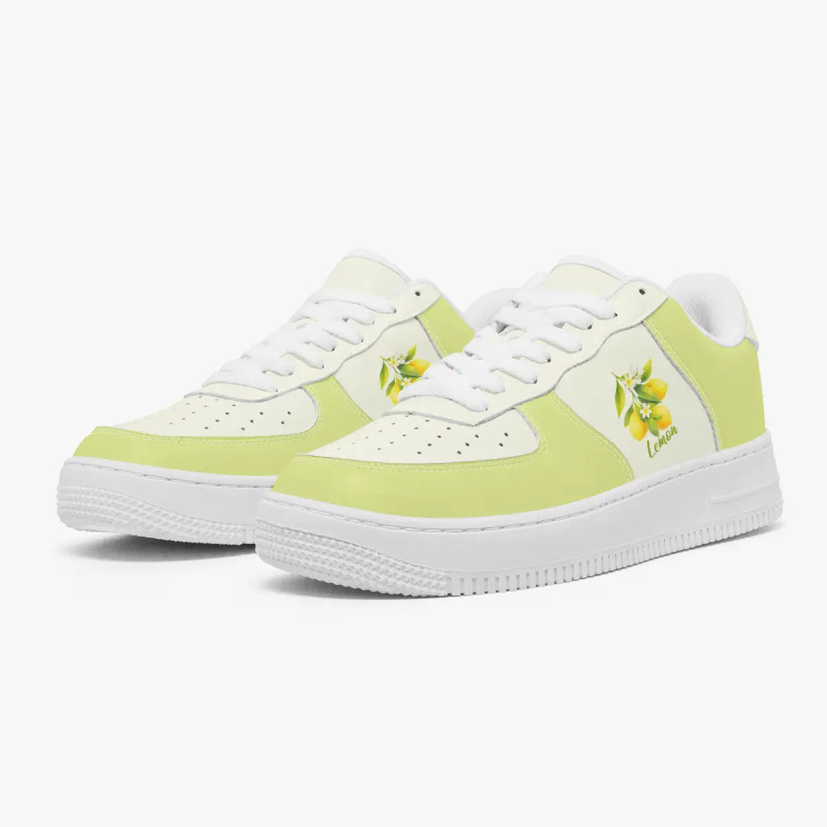 Angled three-quarter view of soft yellow and white sneakers featuring a yellow lemon branch illustration and "Lemon" text printed on the side panel.
