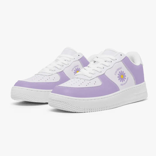 A pair of low-top sneakers in white and light purple, featuring a purple daisy graphic 