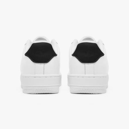 Rear view of white sneakers showing solid black heel tabs above thick white rubber soles.