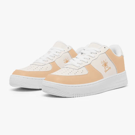 A pair of low-top sneakers in a peach and white colorway, featuring a star logo with the text 'Hazy' on the side, set against a plain light gray background.