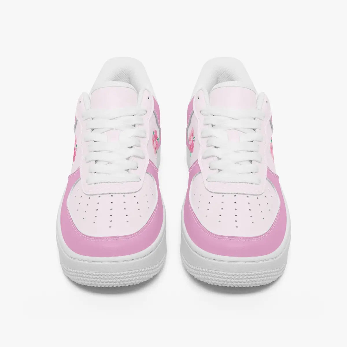 A pair of low-top sneakers shown from the front on a light gray background. The shoes are primarily white with light pink overlays and white laces.