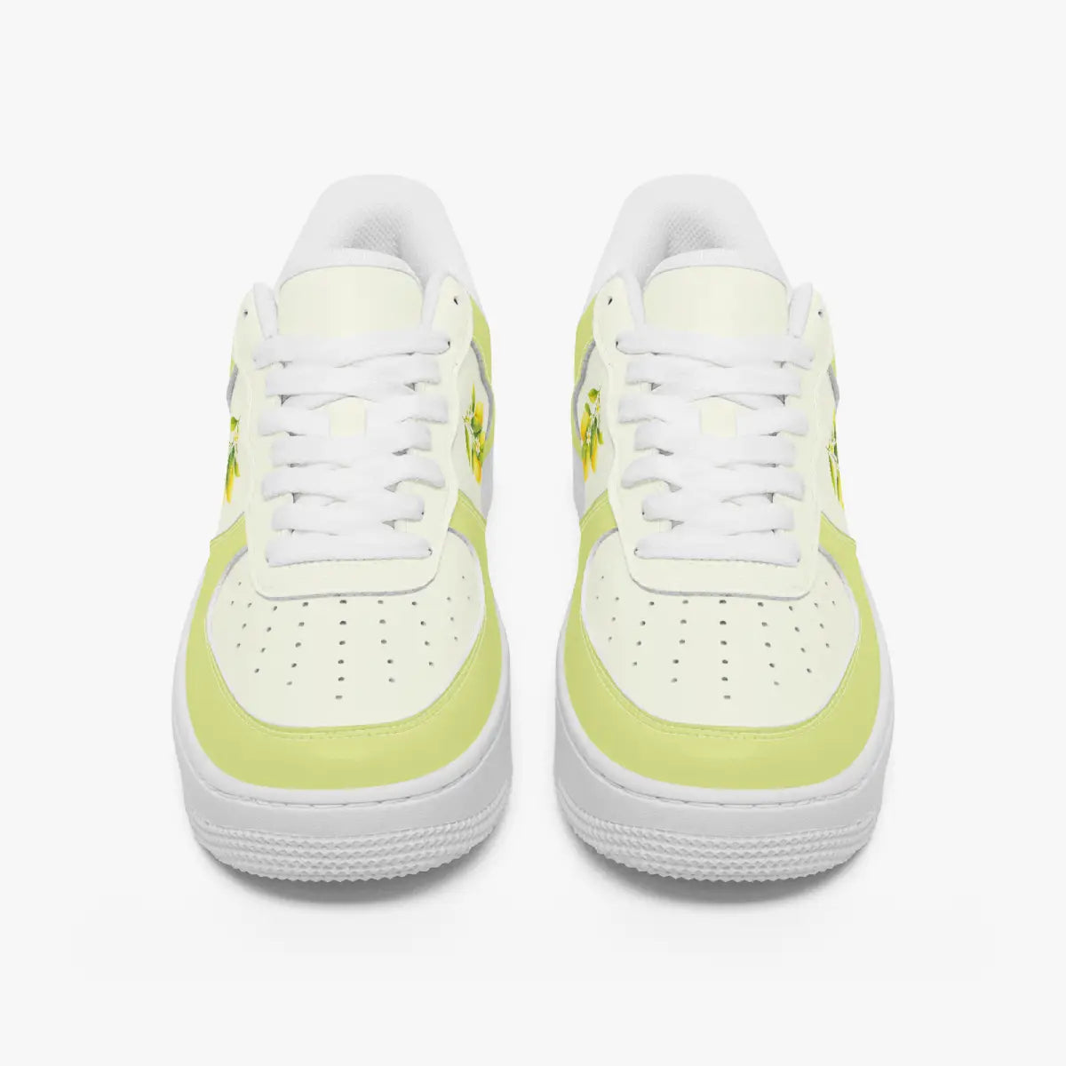 Front view of a pair of pastel yellow and off-white low-top sneakers with white laces and perforated toe caps on a plain background.