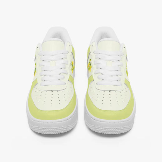 Front view of a pair of pastel yellow and off-white low-top sneakers with white laces and perforated toe caps on a plain background.