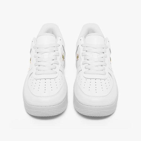 Front view of a pair of minimalist white low-top leather sneakers with matching laces and perforated toe caps on a plain background.