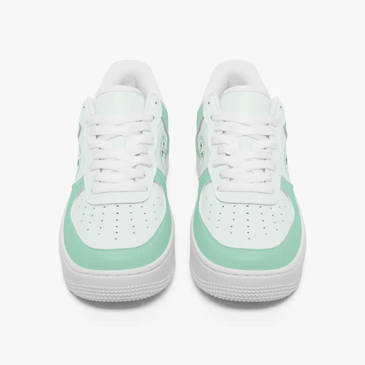 Front view of a pair of mint green and white low-top sneakers with white laces and perforated toe caps on a plain background.