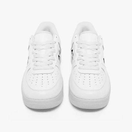 Front view of a pair of all-white low-top leather sneakers with white laces and perforated toe caps on a clean white background.