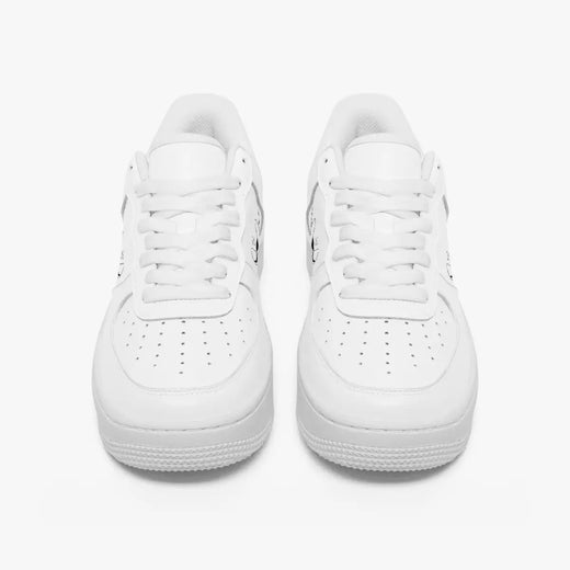 Front view of a pair of minimalist all-white low-top leather sneakers with matching white laces and perforated toe caps on a plain background.