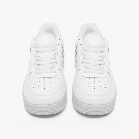 A pair of white low-top sneakers shown from the front on a clean, light gray-white background.