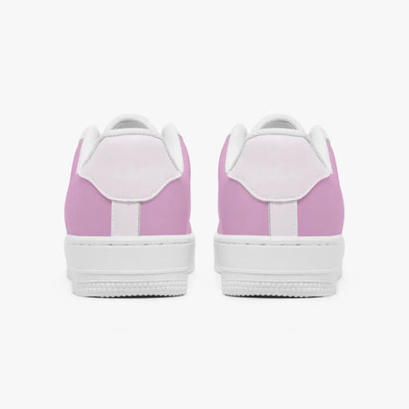 A pair of low-top sneakers shown from the back, featuring a light pink canvas upper with white laces, white midsoles, and white rubber soles, set against a plain light gray background.