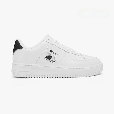 Outer side view of the right sneaker in white leather, highlighting the boy and dog skateboarding graphic and black heel accent facing right.