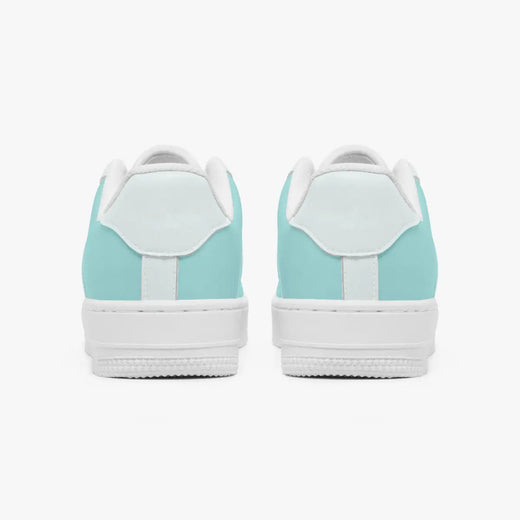 Rear view of mint green and white leather sneakers showing the padded heel counters and textured white rubber outsoles.