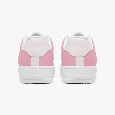 Rear view of a pair of pastel pink low-top sneakers showing the light pink heel tabs and thick white rubber outsoles.