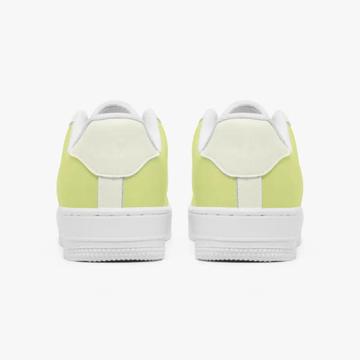 Rear view of a pair of pastel yellow and off-white sneakers showing the padded heel counters and flat white rubber soles.