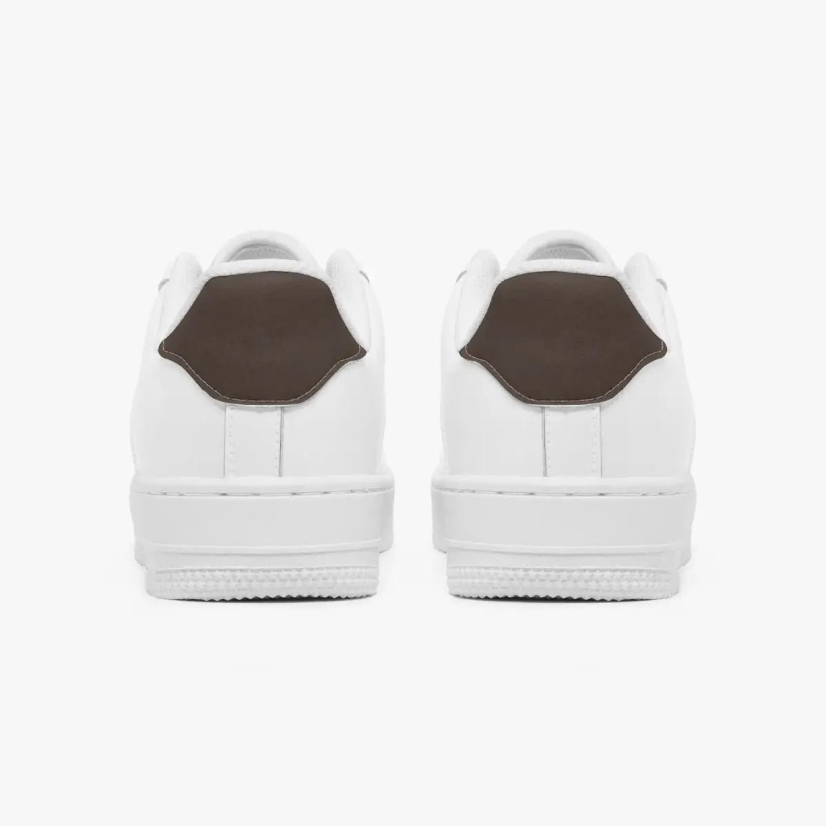 Rear view of white sneakers showing dark charcoal grey heel tabs above solid white rubber soles.