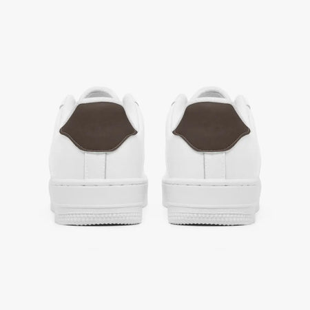 Rear view of white sneakers showing dark charcoal grey heel tabs above solid white rubber soles.