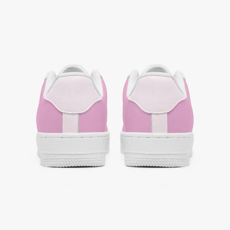 A pair of low-top sneakers shown from the back, featuring light pink panels on the sides and heel, a white leather tongue, and a thick white rubber sole.