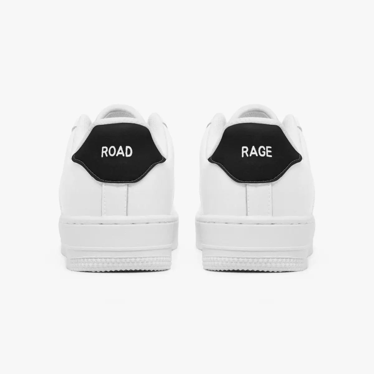 Rear view of white low-top sneakers showing contrasting black heel tabs labeled "ROAD" and "RAGE" above flat white rubber soles.