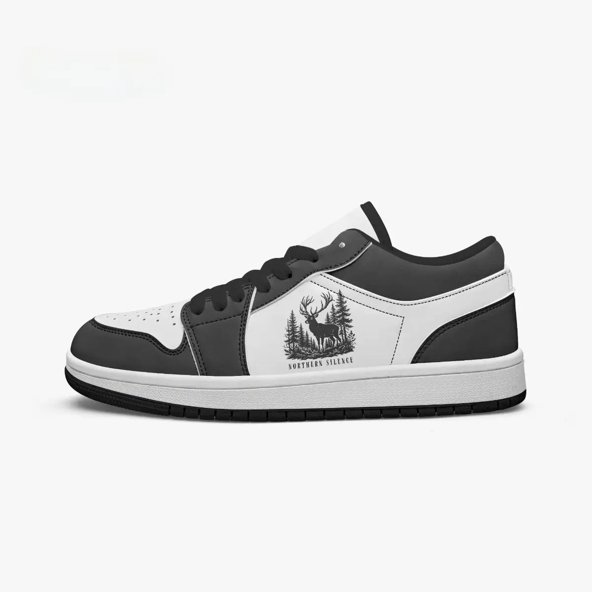Side profile view of the right low-top sneaker in charcoal black and white leather, featuring a deer in a pine forest graphic with "NORTHERN SILENCE", black laces, and a black inner lining facing right.