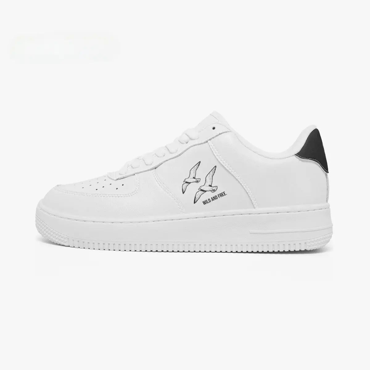 Side profile view of the left sneaker in white leather, highlighting the "WILD AND FREE" soaring birds illustration, black heel tab accent, white laces, and flat white cupsole facing right.