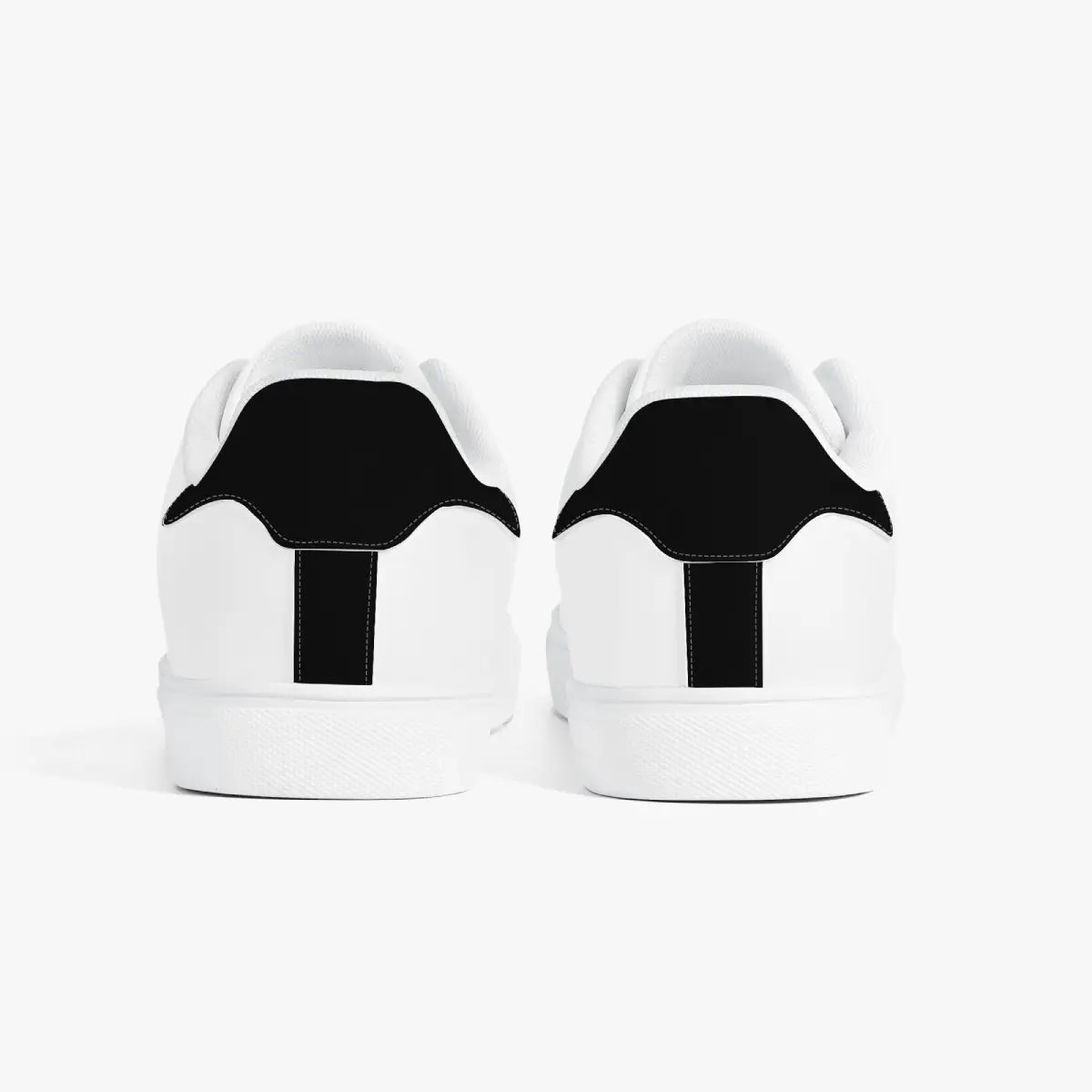 Rear view of minimalist white leather sneakers highlighting black heel tab overlays, white padded collars, and clean white rubber midsoles.