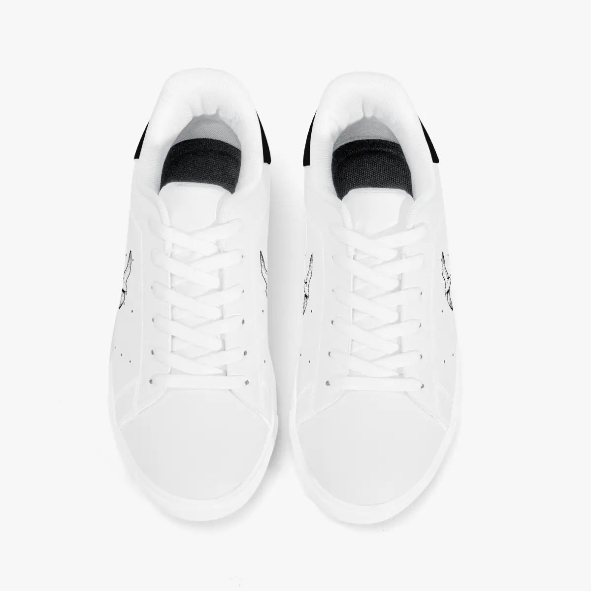 Overhead view of white leather sneakers showing clean white laces, white interior linings, and smooth white rounded toe boxes.